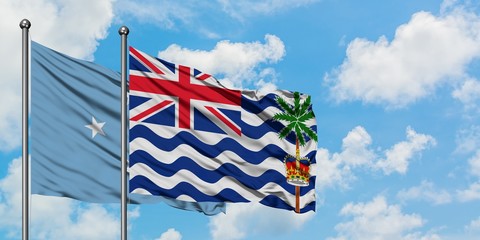 Micronesia and British Indian Ocean Territory flag waving in the wind against white cloudy blue sky together. Diplomacy concept, international relations.