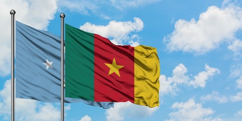 Micronesia and Cameroon flag waving in the wind against white cloudy blue sky together. Diplomacy concept, international relations.