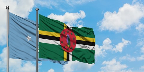 Micronesia and Dominica flag waving in the wind against white cloudy blue sky together. Diplomacy...