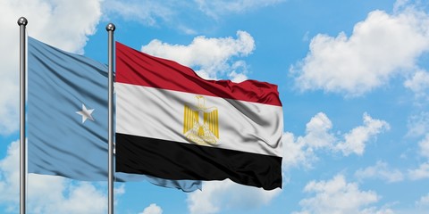 Micronesia and Egypt flag waving in the wind against white cloudy blue sky together. Diplomacy concept, international relations.