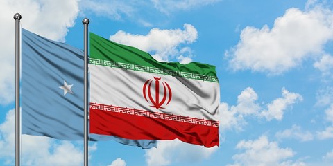 Micronesia and Iran flag waving in the wind against white cloudy blue sky together. Diplomacy concept, international relations.