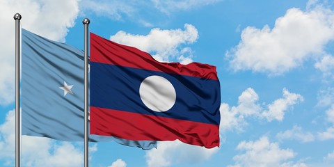 Micronesia and Laos flag waving in the wind against white cloudy blue sky together. Diplomacy concept, international relations.