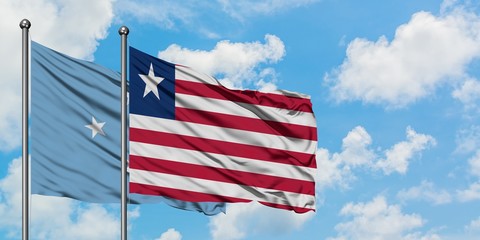 Obraz premium Micronesia and Liberia flag waving in the wind against white cloudy blue sky together. Diplomacy concept, international relations.
