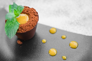 Chocolate fondant mint sprout in pot of earth dessert pudding with ice cream on plate