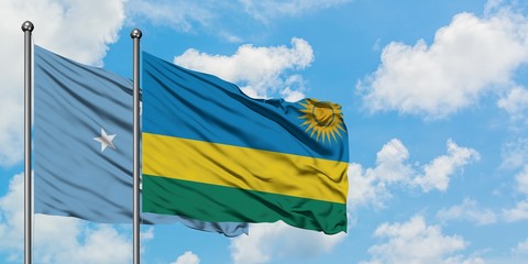Micronesia and Rwanda flag waving in the wind against white cloudy blue sky together. Diplomacy concept, international relations.