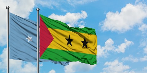 Micronesia and Sao Tome And Principe flag waving in the wind against white cloudy blue sky together. Diplomacy concept, international relations.
