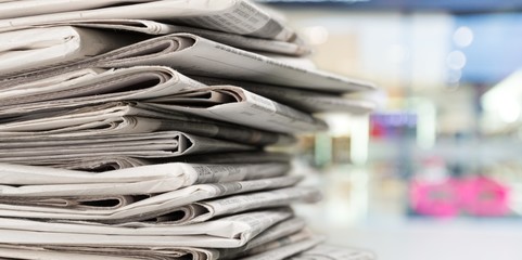 Pile of newspapers on background, close-up view