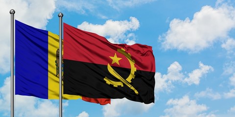 Moldova and Angola flag waving in the wind against white cloudy blue sky together. Diplomacy concept, international relations.