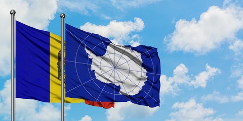 Moldova and Antarctica flag waving in the wind against white cloudy blue sky together. Diplomacy concept, international relations.