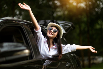 Asian women travel relax in the holiday. Traveling by car park. happily With nature, rural forest....