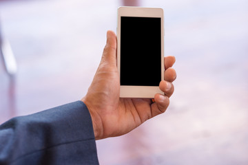 Hand businessman with White smartphone . business communication concept.