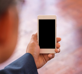 White smartphone with black blank in Hand businessman. business communication concept.