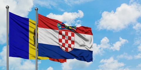 Moldova and Croatia flag waving in the wind against white cloudy blue sky together. Diplomacy concept, international relations.
