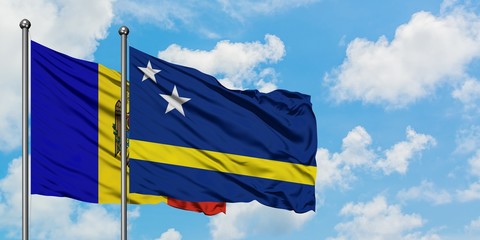 Moldova and Curacao flag waving in the wind against white cloudy blue sky together. Diplomacy concept, international relations.
