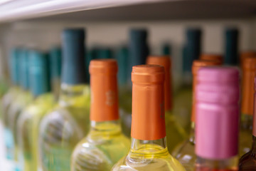 Wine bottles kept cold in a fridge