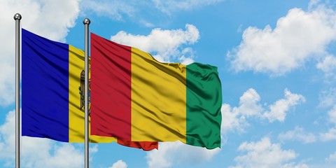 Moldova and Guinea flag waving in the wind against white cloudy blue sky together. Diplomacy concept, international relations.