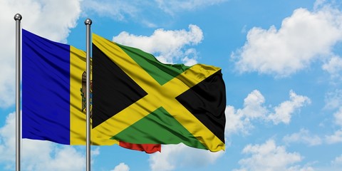 Moldova and Jamaica flag waving in the wind against white cloudy blue sky together. Diplomacy concept, international relations.