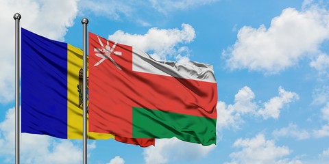 Moldova and Oman flag waving in the wind against white cloudy blue sky together. Diplomacy concept, international relations.