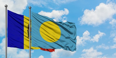 Moldova and Palau flag waving in the wind against white cloudy blue sky together. Diplomacy concept, international relations.