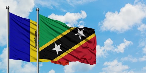 Moldova and Saint Kitts And Nevis flag waving in the wind against white cloudy blue sky together. Diplomacy concept, international relations.