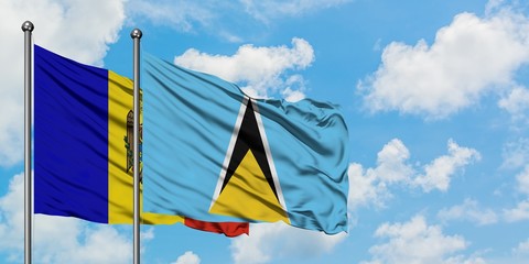 Moldova and Saint Lucia flag waving in the wind against white cloudy blue sky together. Diplomacy concept, international relations.