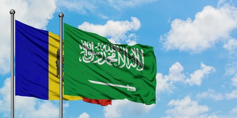 Moldova and Saudi Arabia flag waving in the wind against white cloudy blue sky together. Diplomacy concept, international relations.