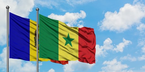 Moldova and Senegal flag waving in the wind against white cloudy blue sky together. Diplomacy...