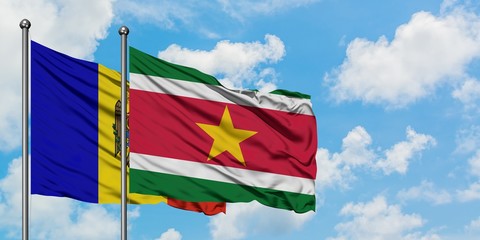 Moldova and Suriname flag waving in the wind against white cloudy blue sky together. Diplomacy concept, international relations.