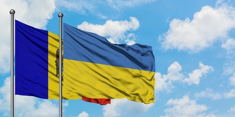 Moldova and Ukraine flag waving in the wind against white cloudy blue sky together. Diplomacy concept, international relations.