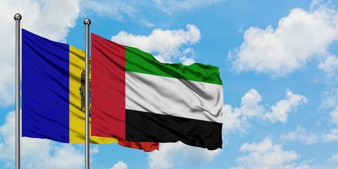 Moldova and United Arab Emirates flag waving in the wind against white cloudy blue sky together. Diplomacy concept, international relations.