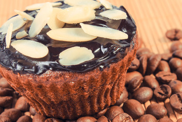 Fresh baked muffin with coffee, chocolate and almonds. Delicious dessert