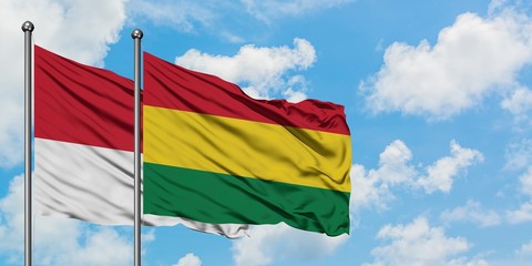 Monaco and Bolivia flag waving in the wind against white cloudy blue sky together. Diplomacy concept, international relations.