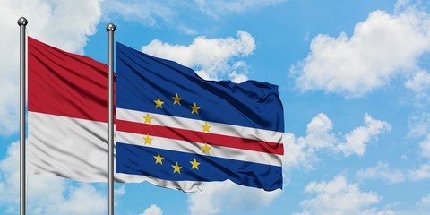 Monaco and Cape Verde flag waving in the wind against white cloudy blue sky together. Diplomacy concept, international relations.