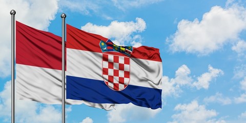 Monaco and Croatia flag waving in the wind against white cloudy blue sky together. Diplomacy concept, international relations.