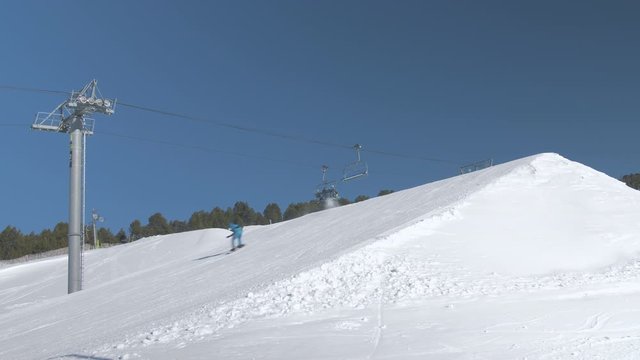 Moving Chair Lift in Ski Resort with Snowpark on Sunny Weather Day 1