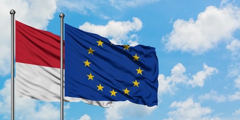 Monaco and European Union flag waving in the wind against white cloudy blue sky together. Diplomacy concept, international relations.