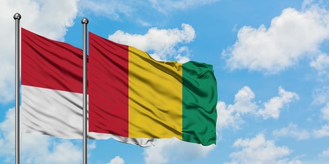 Monaco and Guinea flag waving in the wind against white cloudy blue sky together. Diplomacy concept, international relations.