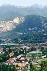 Fototapeta na wymiar Aerial view with Landscape of Arco town at rock at Sarca Valley near Garda lake of Trentino in Italy. Scenery with cityscape and mountain at Arco old city in Trento near Riva del Garda. Outdoor