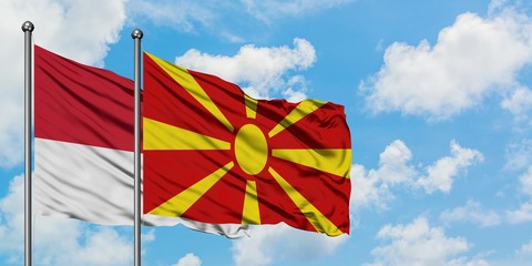 Monaco and Macedonia flag waving in the wind against white cloudy blue sky together. Diplomacy concept, international relations.