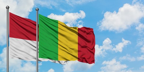 Monaco and Mali flag waving in the wind against white cloudy blue sky together. Diplomacy concept, international relations.