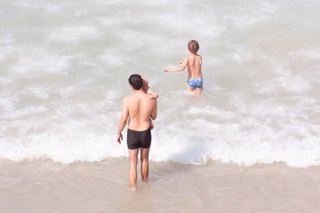 Fototapeta premium Background with dad and his children on the beach