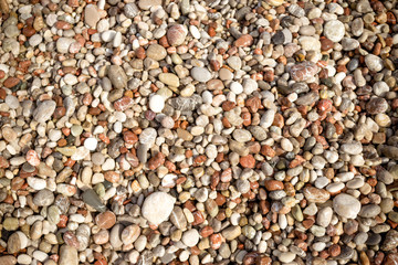 Pebble stone background.Small colorful pebbles background, simplicity, daylight, stones.smooth waterworn pebble use for garden decoration.Relaxing on the beach.abstract background with round peeble
