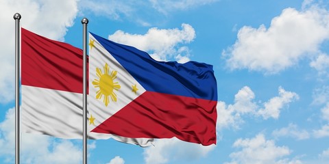 Monaco and Philippines flag waving in the wind against white cloudy blue sky together. Diplomacy concept, international relations.