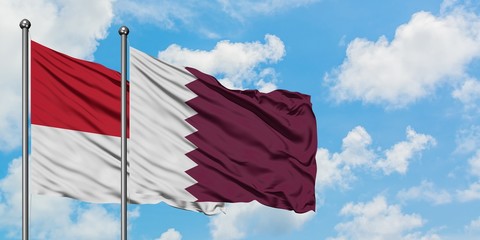 Monaco and Qatar flag waving in the wind against white cloudy blue sky together. Diplomacy concept,...