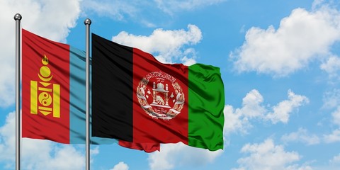 Mongolia and Afghanistan flag waving in the wind against white cloudy blue sky together. Diplomacy concept, international relations.
