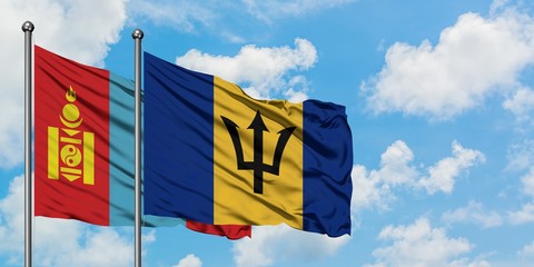 Mongolia and Barbados flag waving in the wind against white cloudy blue sky together. Diplomacy concept, international relations.