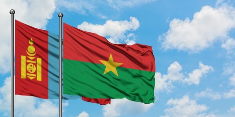 Mongolia and Burkina Faso flag waving in the wind against white cloudy blue sky together. Diplomacy concept, international relations.