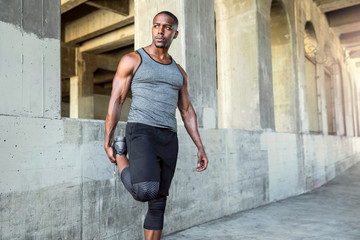 Handsome african american black athlete runner, jogger, stretching for fitness and exercise cardio...