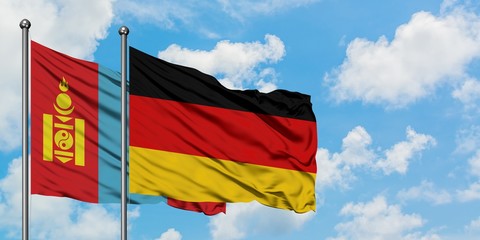 Mongolia and Germany flag waving in the wind against white cloudy blue sky together. Diplomacy concept, international relations.