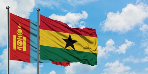 Mongolia and Ghana flag waving in the wind against white cloudy blue sky together. Diplomacy concept, international relations.